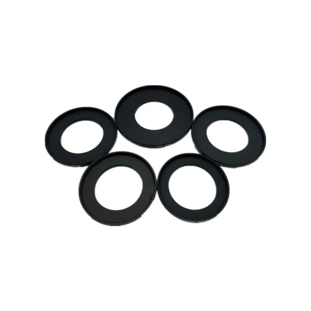 Five black 37mm step-up filter adapter rings laid flat on a white background