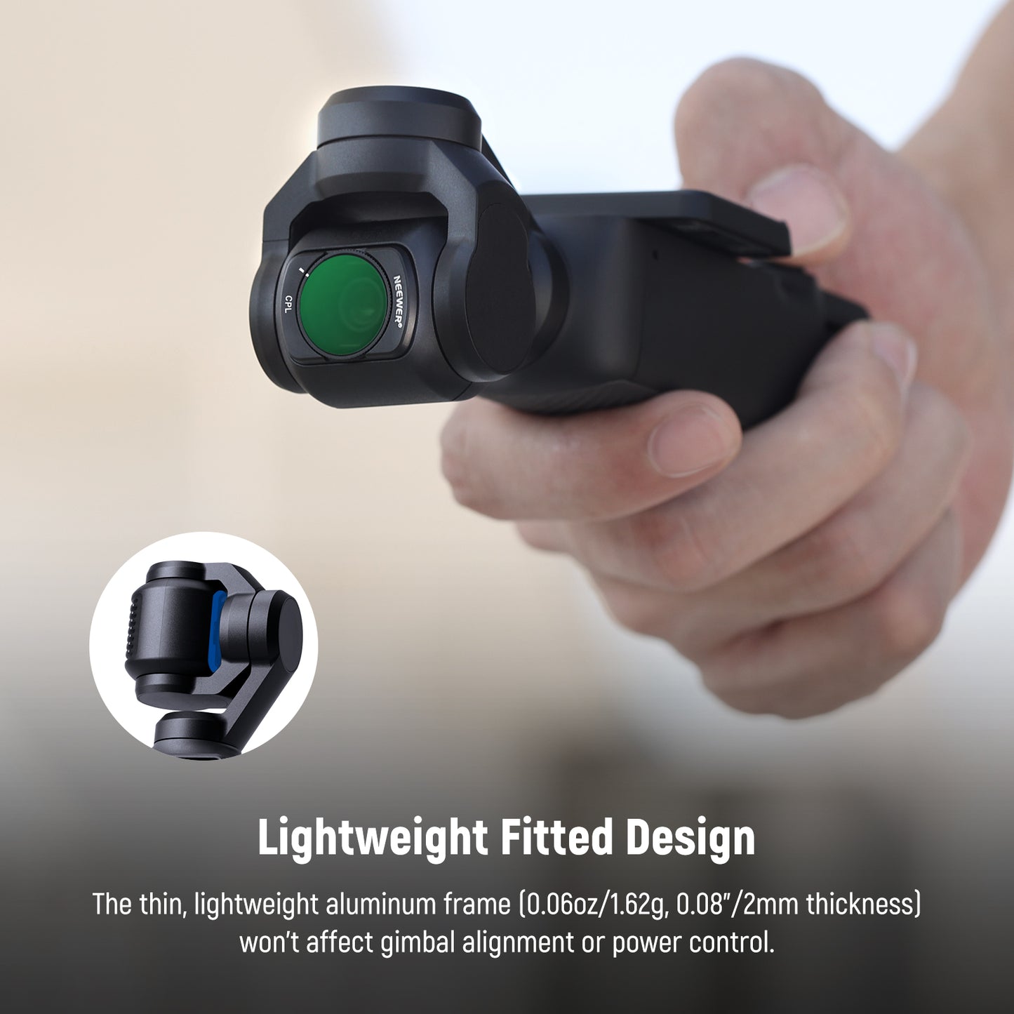 Hand holding a black gimbal with a close-up inset, on a blurred background