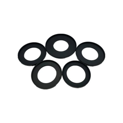 Five black 37mm step-up filter adapter rings laid flat on a white background