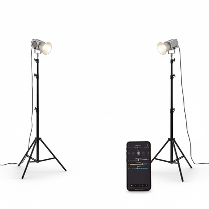 Two studio lights on stands with a smartphone displaying control app on a white background