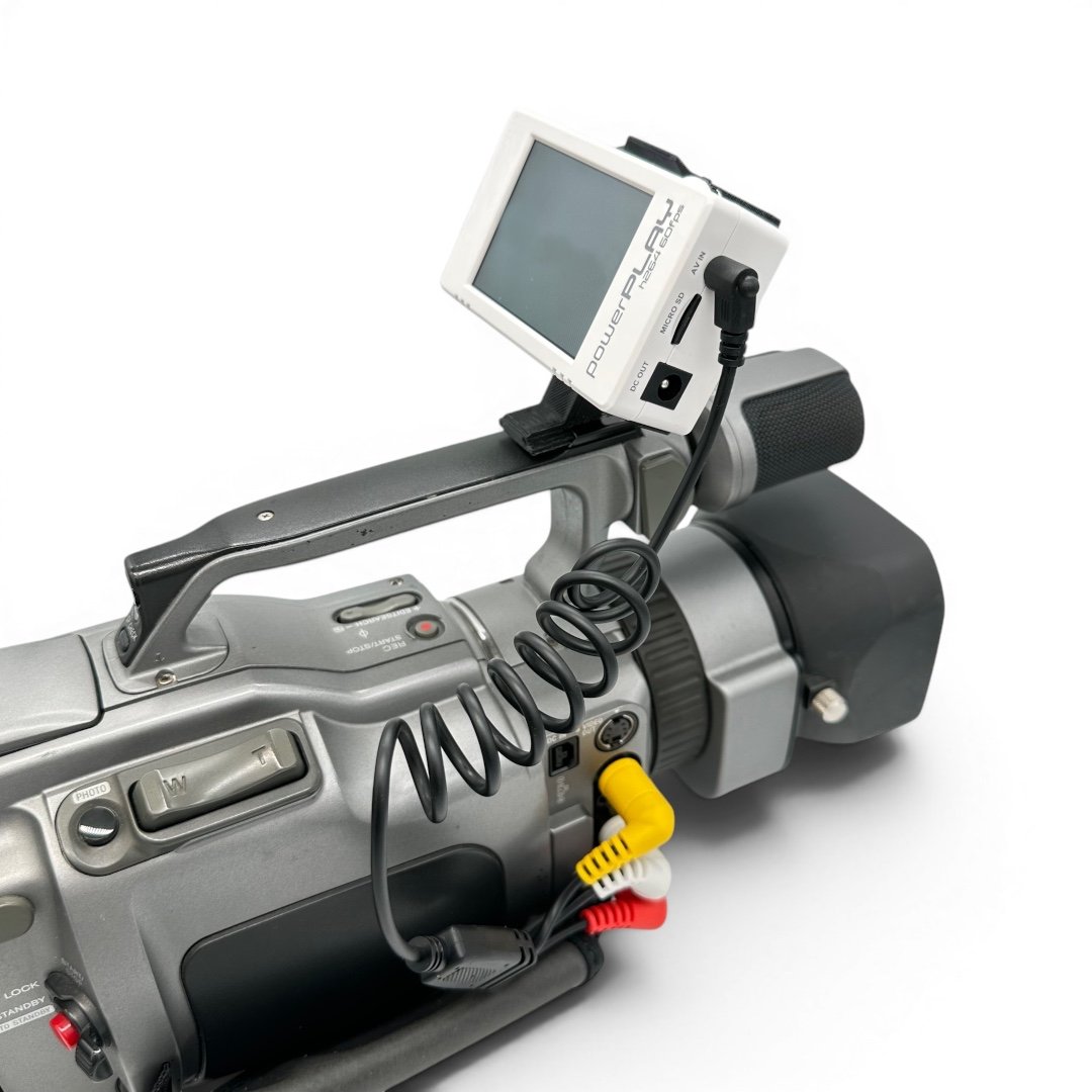 ImmersionRC PowerPlay DVR mounted on a Sony VX-series MiniDV camcorder using the head strap clip, connected via the 3-RCA A/V cable