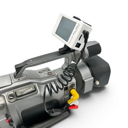ImmersionRC PowerPlay DVR mounted on a Sony VX-series MiniDV camcorder using the head strap clip, connected via the 3-RCA A/V cable